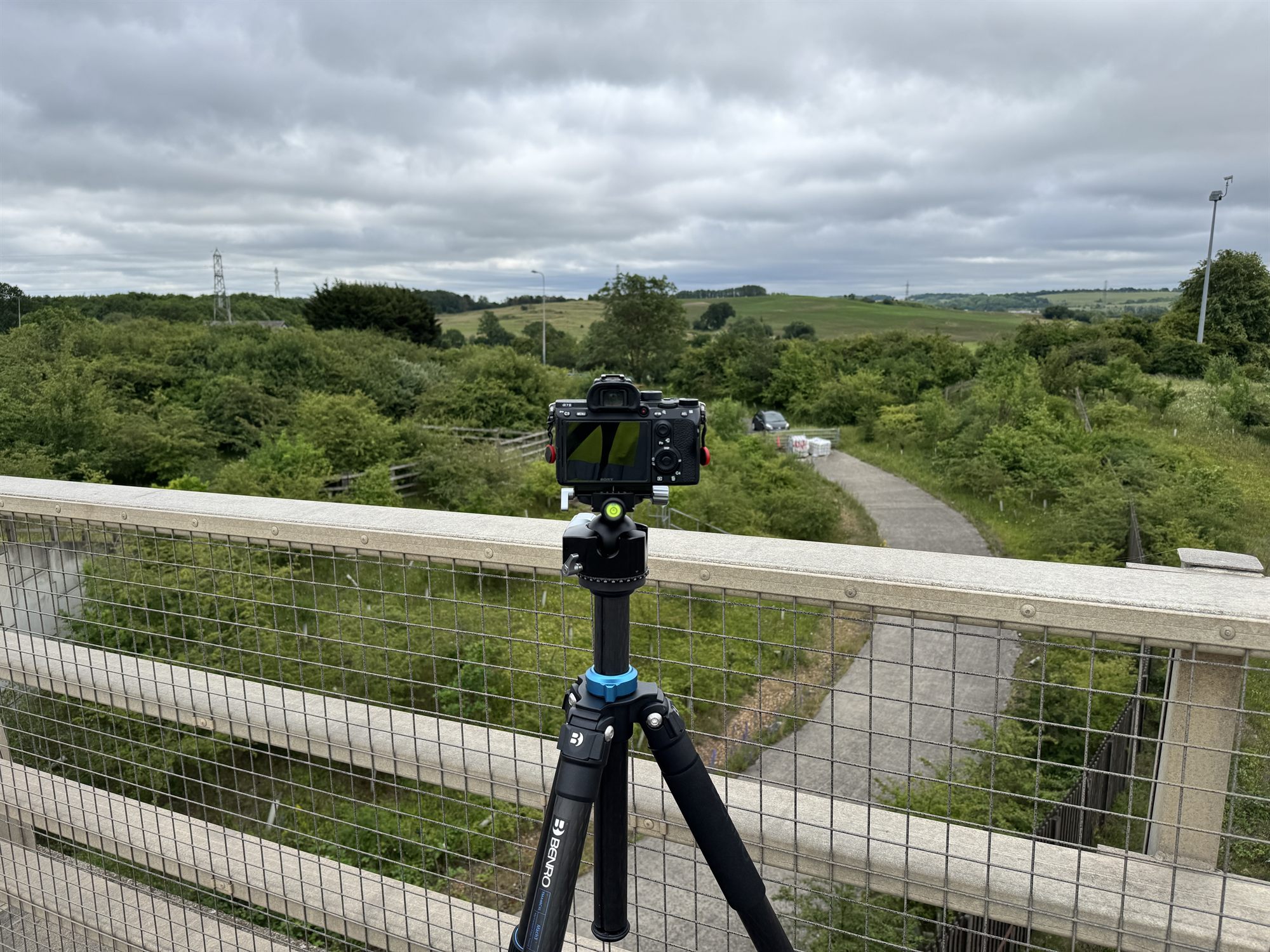 Camera on a levelled survey tripod capturing a located viewpoint over a development site